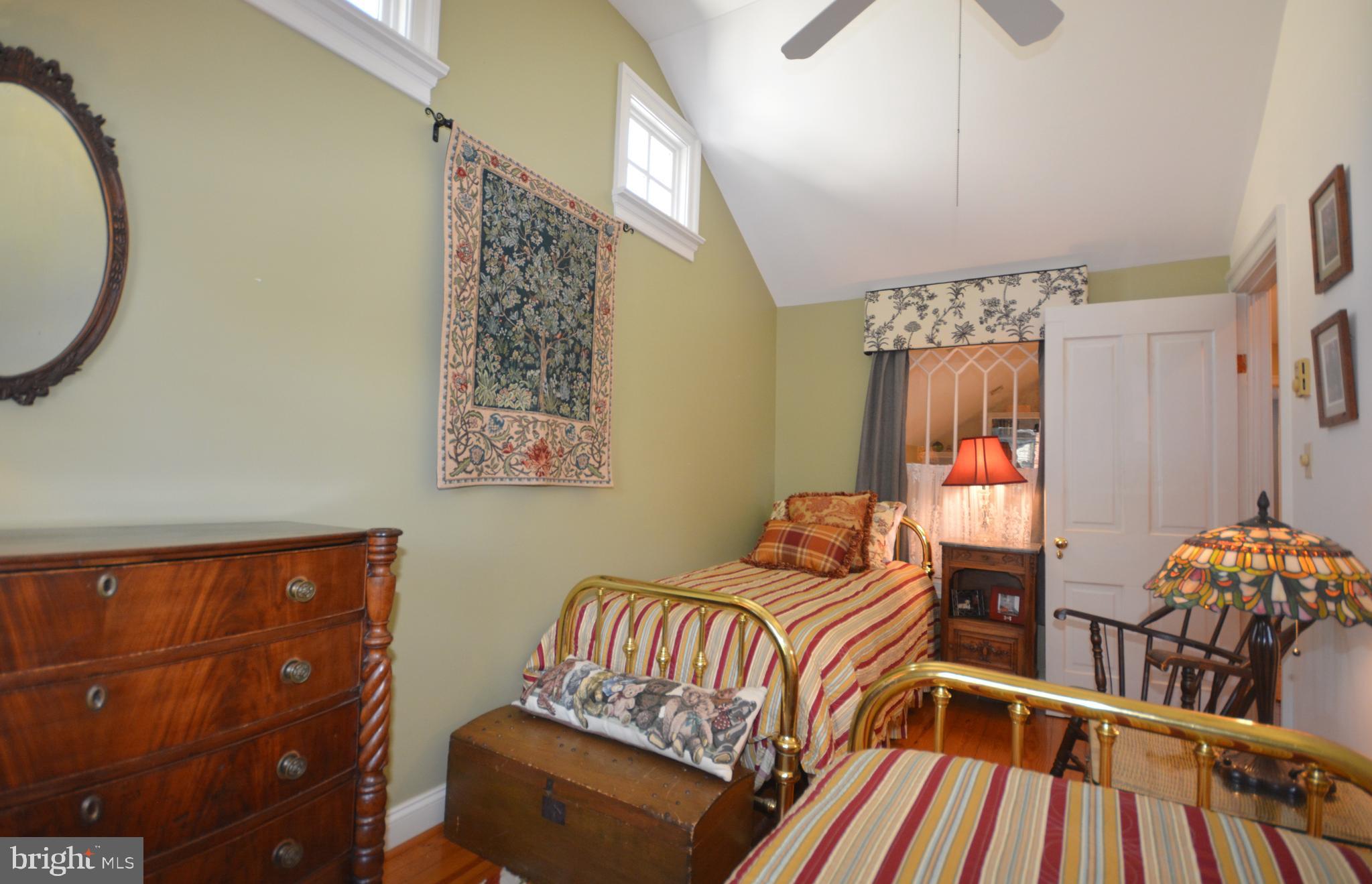 106 Grace Street St. Michaels, MD 21663 - Photo 47 of 57 a bedroom with a bed and wooden floor