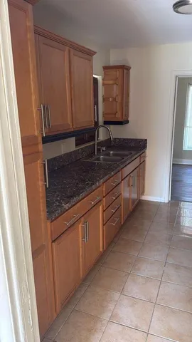 a kitchen with granite countertop a sink and a stove