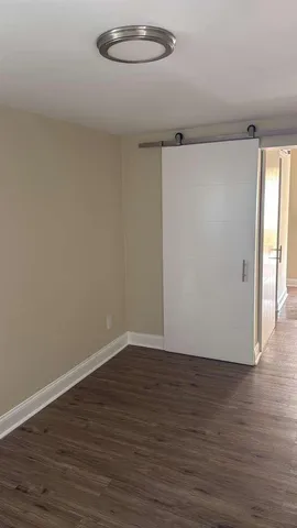 a view of a room with wooden floor
