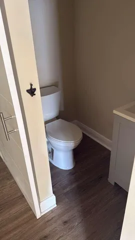a toilet in a bathroom next to a sink