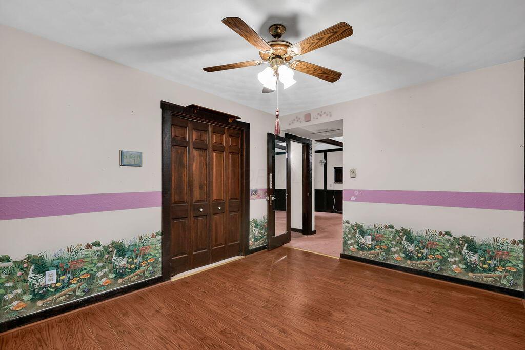 4409 Newton Road Northeast Newark, OH 43055 - Photo 51 of 87 • Neutral vinyl flooring • Ivory painted walls • Lighted ceiling fan • Faux fireplace • Lighted closet with bi-fold doors
