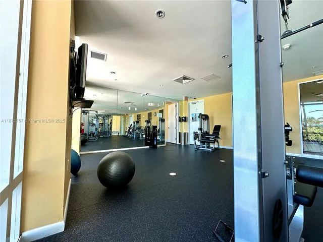 a view of a tall building next to a yard