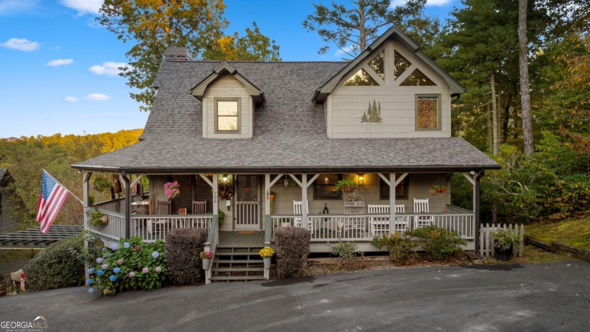 an outdoor view of house along with deck and outdoor seating