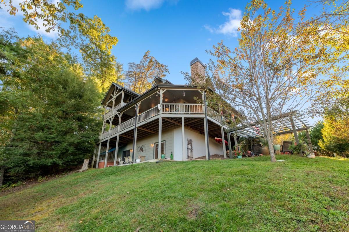 709 Laurel Creek Trail Blue Ridge, GA 30513 - Photo 22 of 87 a view of a house with a big yard and large trees
