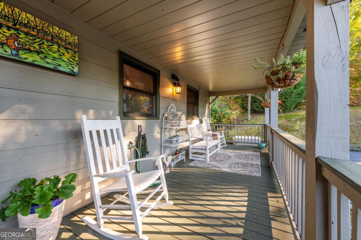 709 Laurel Creek Trail Blue Ridge, GA 30513 - Photo 53 of 87 a view of a patio with table and chairs and potted plants