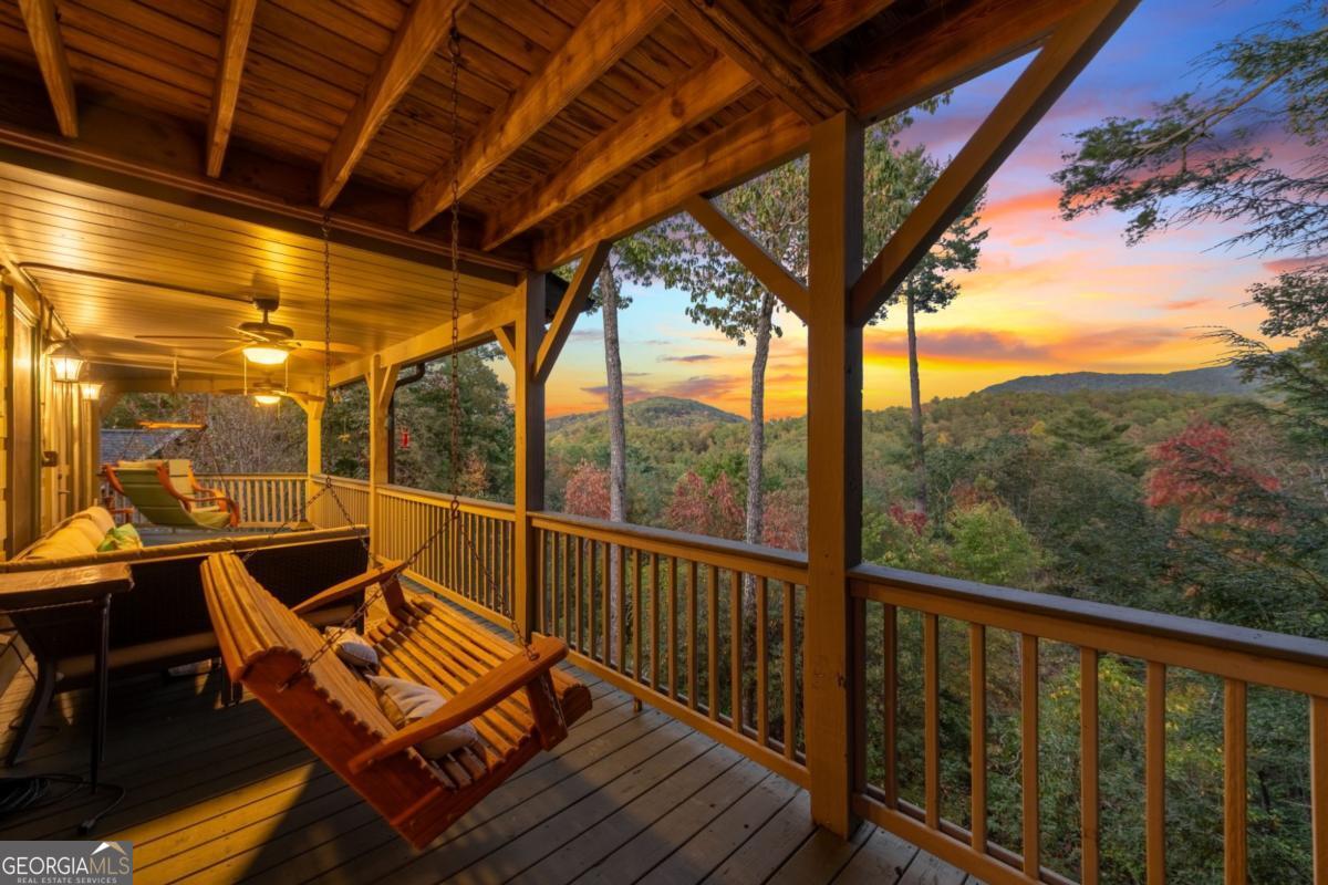 709 Laurel Creek Trail Blue Ridge, GA 30513 - Photo 57 of 87 a view of a balcony with chairs and wooden floor