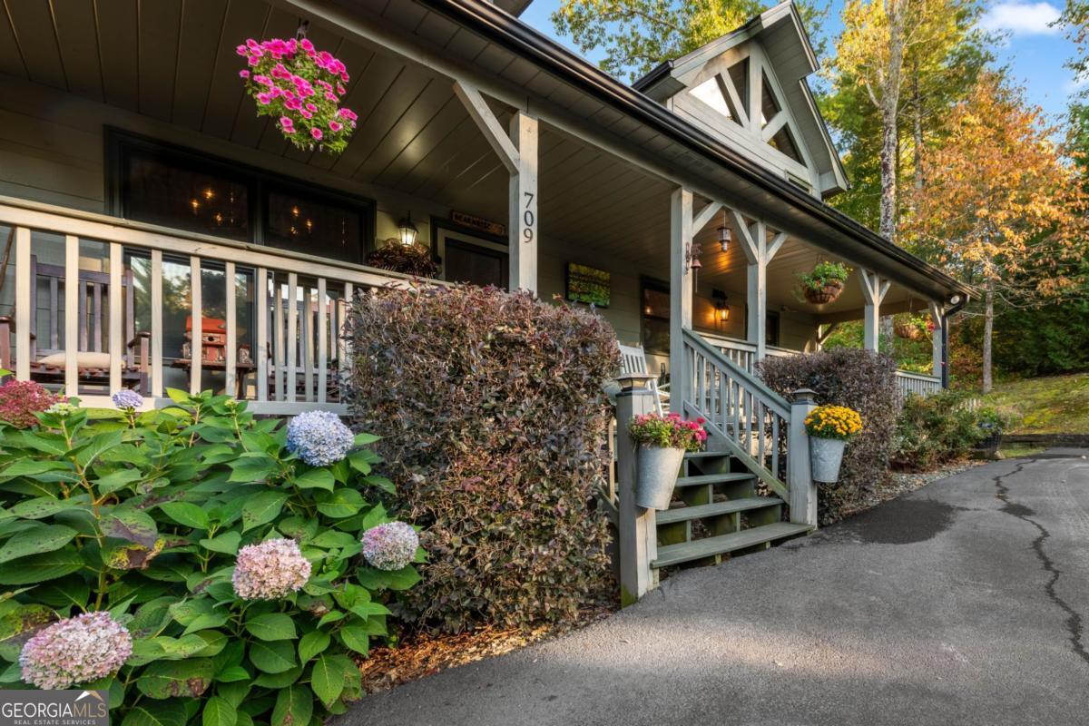 709 Laurel Creek Trail Blue Ridge, GA 30513 - Photo 58 of 87 a front view of a house with a yard and flowers