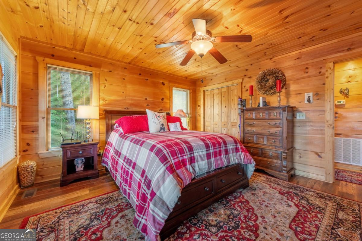 709 Laurel Creek Trail Blue Ridge, GA 30513 - Photo 64 of 87 a bed sitting in a bedroom next to a window