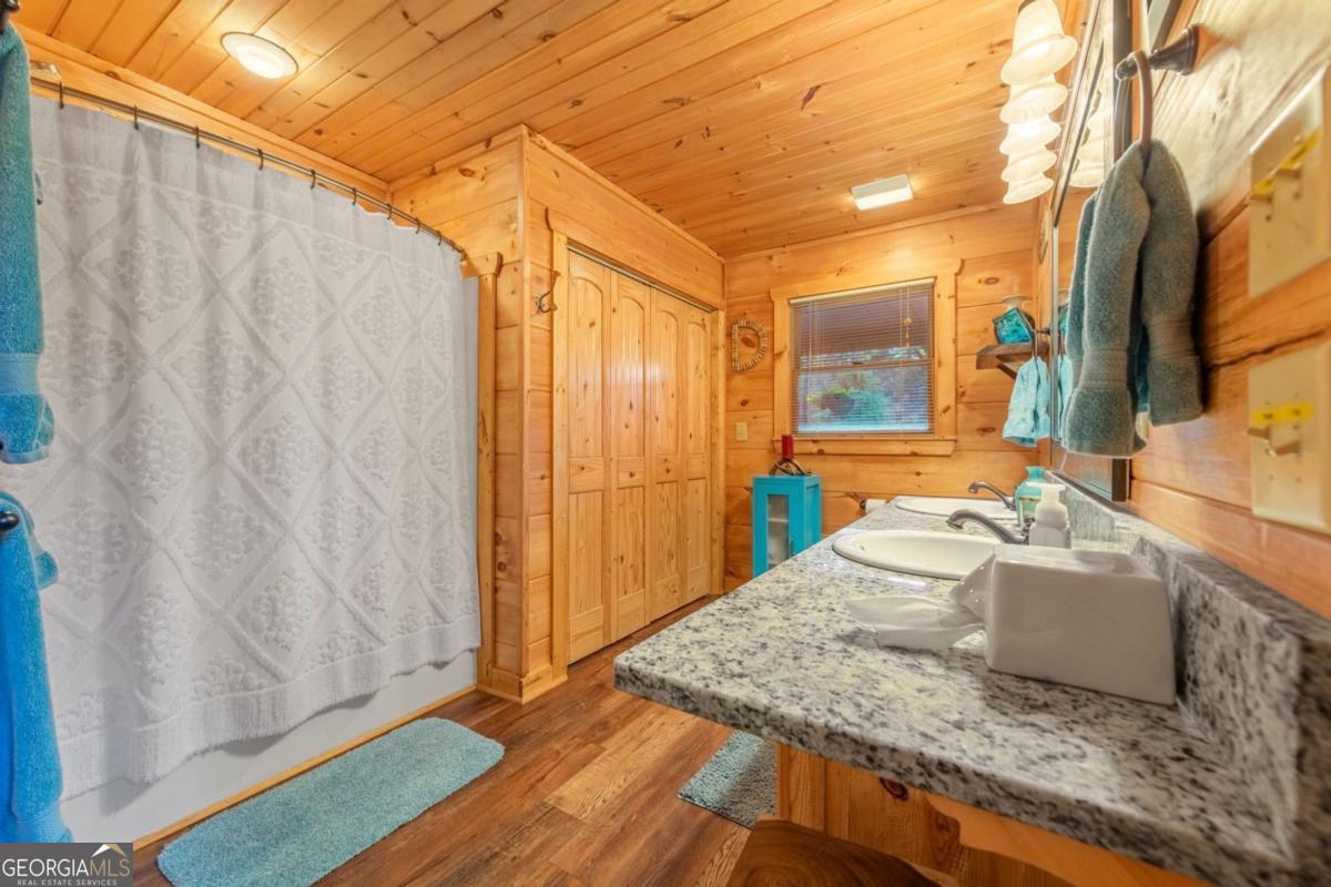 709 Laurel Creek Trail Blue Ridge, GA 30513 - Photo 71 of 87 a bathroom with a granite countertop sink and a mirror
