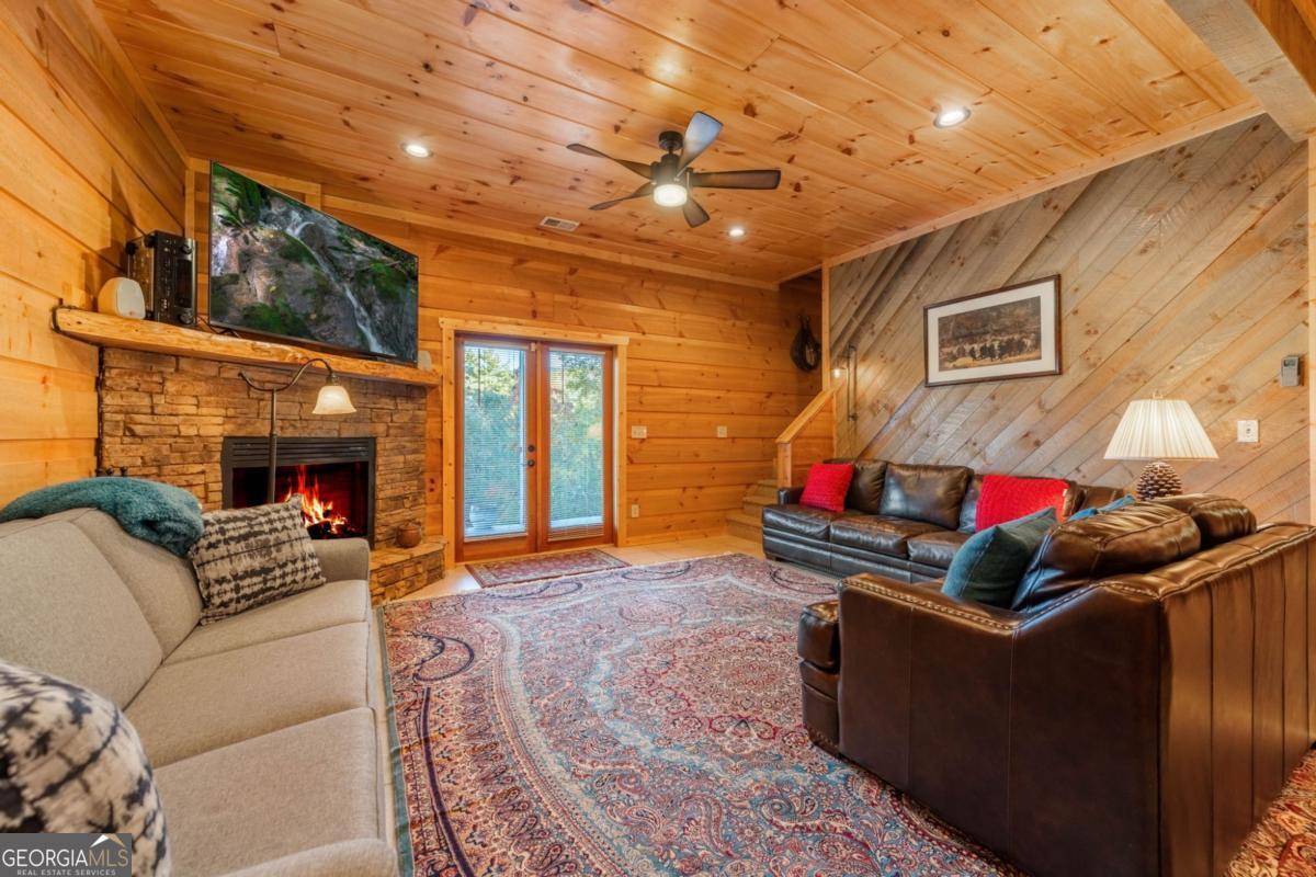 709 Laurel Creek Trail Blue Ridge, GA 30513 - Photo 74 of 87 a living room with furniture and a fireplace
