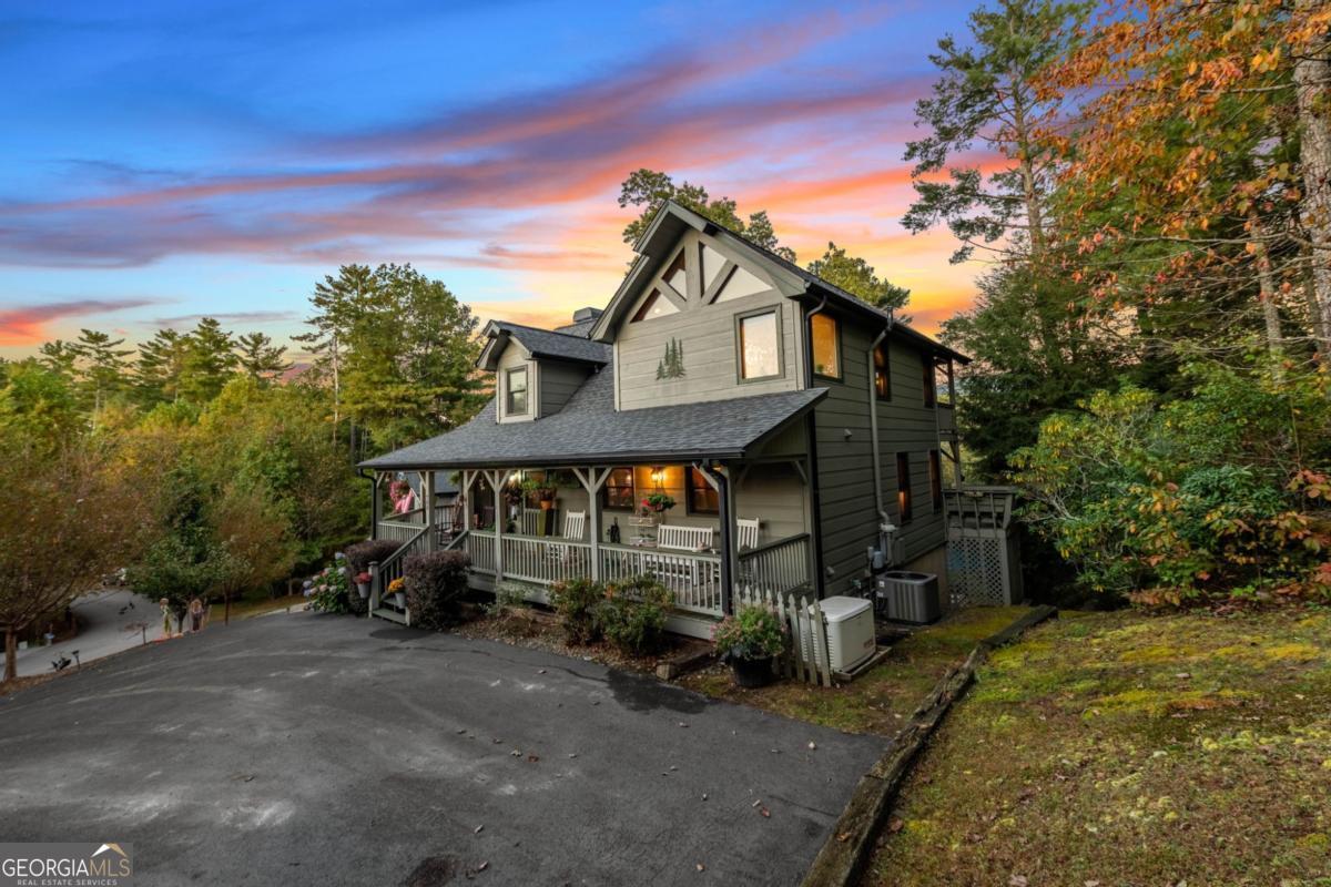 709 Laurel Creek Trail Blue Ridge, GA 30513 - Photo 76 of 87 a front view of a house with a garden