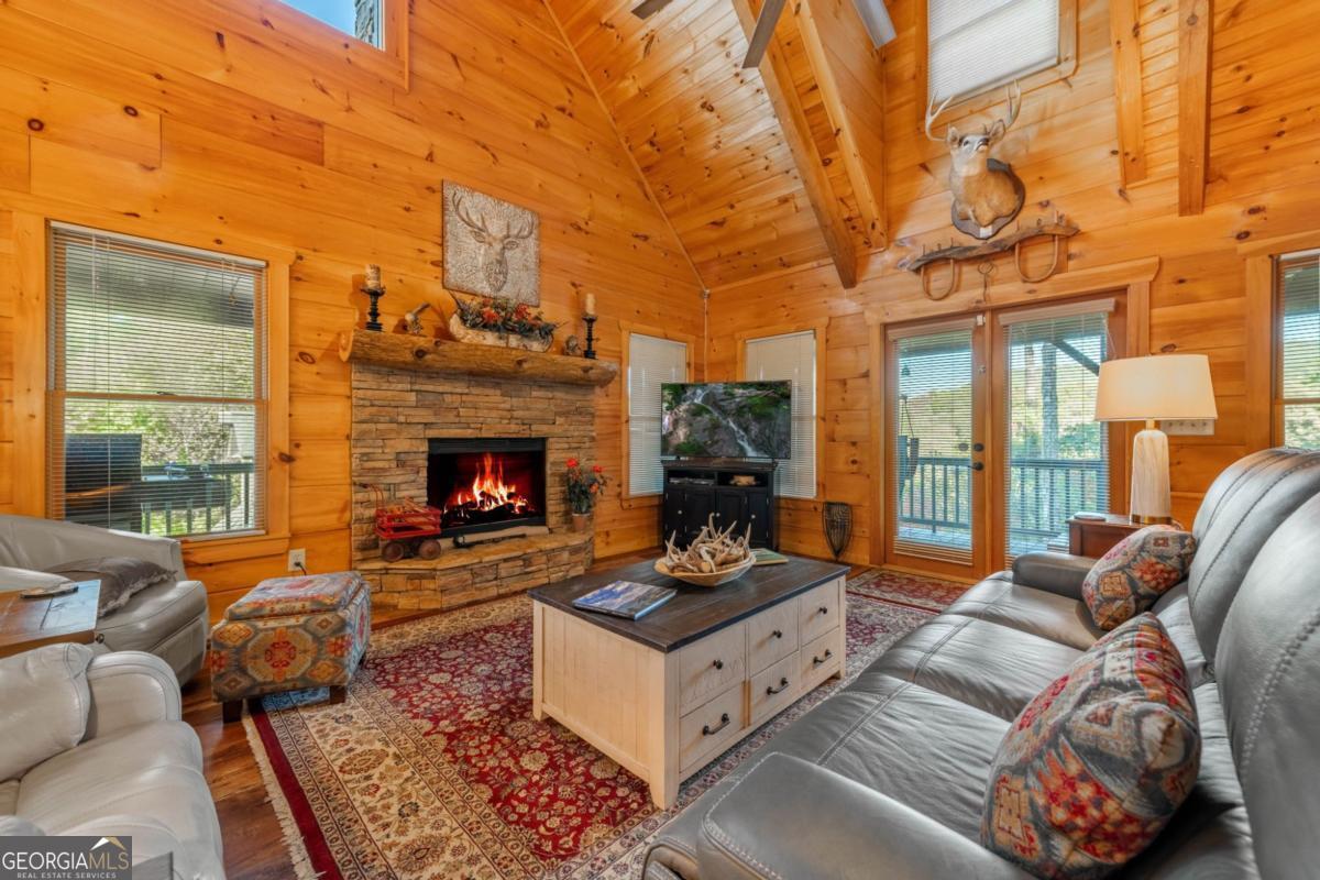 709 Laurel Creek Trail Blue Ridge, GA 30513 - Photo 87 of 87 a living room with furniture a fireplace and a large window