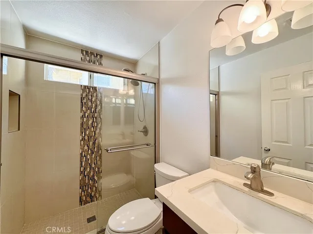 a bathroom with a sink toilet and shower