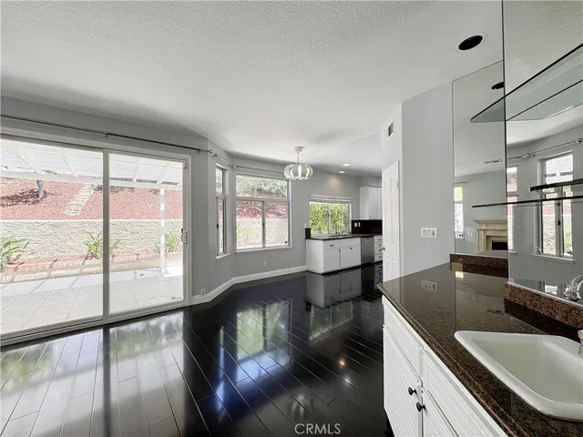 a large white kitchen with kitchen island a sink a stove and refrigerator