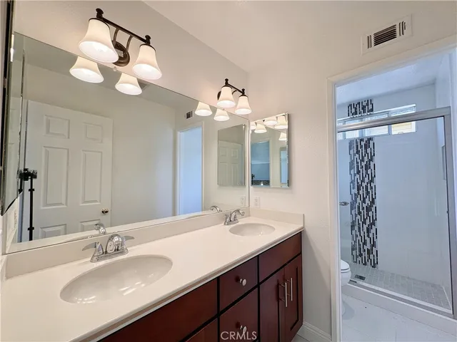 a bathroom with a sink vanity and a mirror