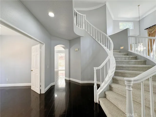 a view of entryway and hall with wooden floor