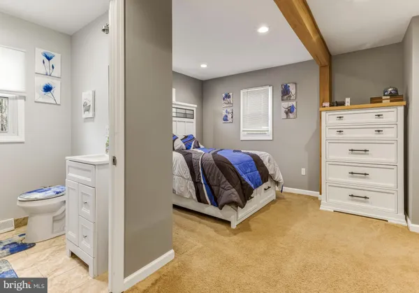a living room with a baby crib furniture and a toilet