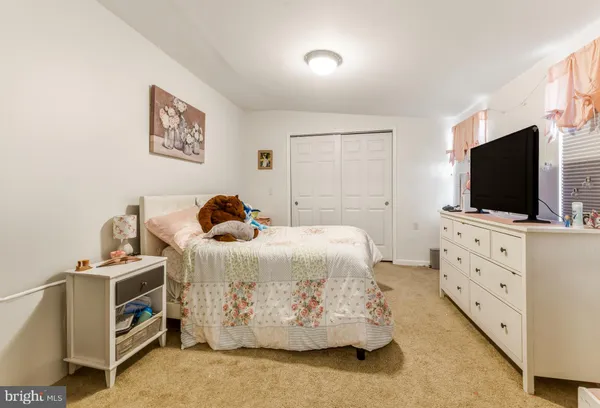 a bedroom with a bed and flat screen tv