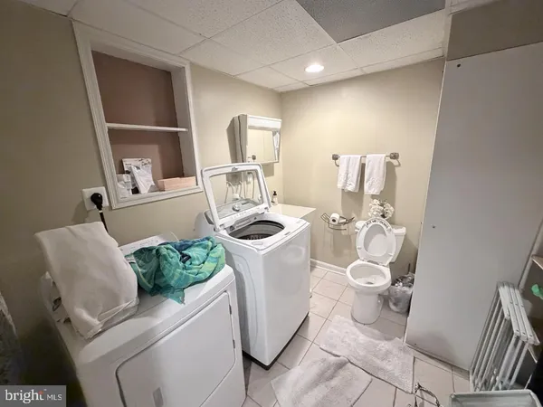 a white toilet sitting next to a bathroom sink and tub