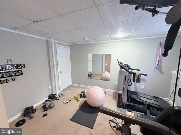 a room with furniture and gym equipment