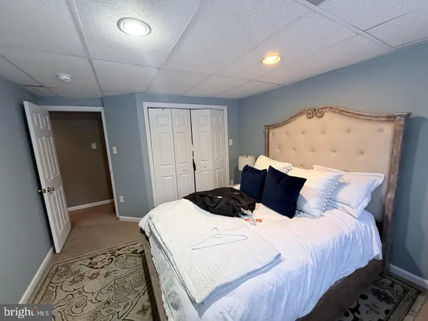 a bedroom with a bed and a mirror