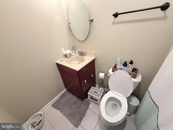 a bathroom with a sink mirror vanity and toilet