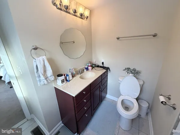a bathroom with a sink mirror and toilet