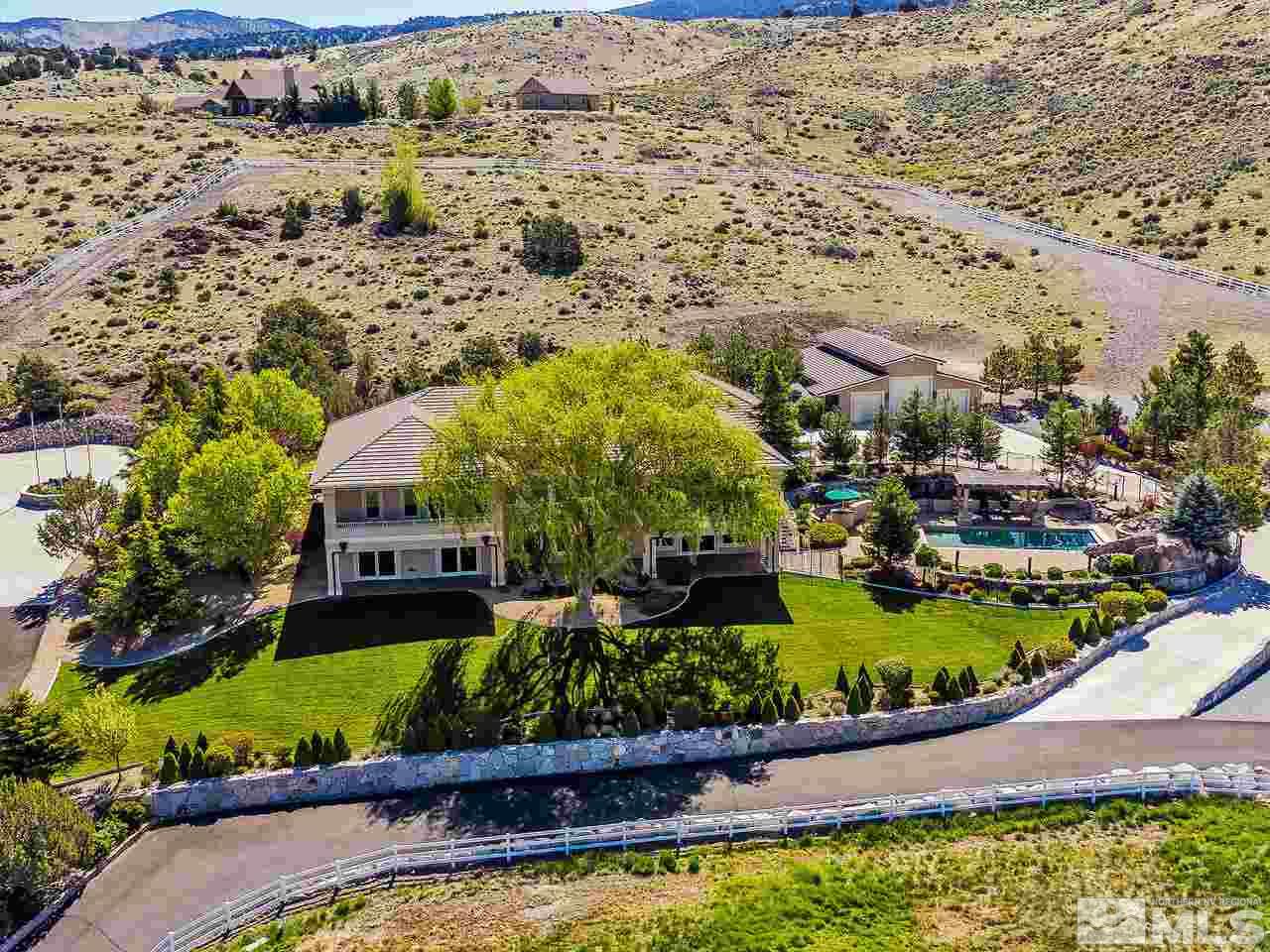 1180 Paddock Lane Reno, NV 89521 - Photo 1 of 25 an aerial view of a house with a garden and lake view