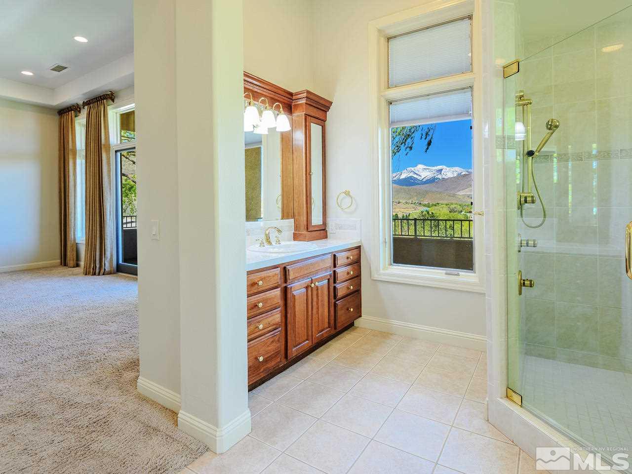 1180 Paddock Lane Reno, NV 89521 - Photo 12 of 25 a spacious bathroom with a mirror a bathtub and shower