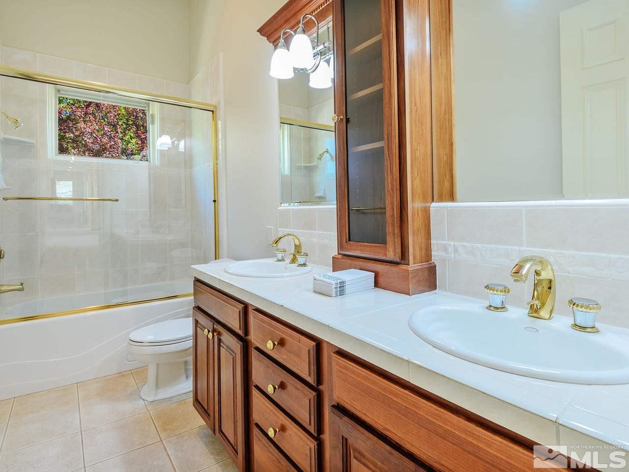 1180 Paddock Lane Reno, NV 89521 - Photo 14 of 25 a bathroom with a sink a toilet and shower