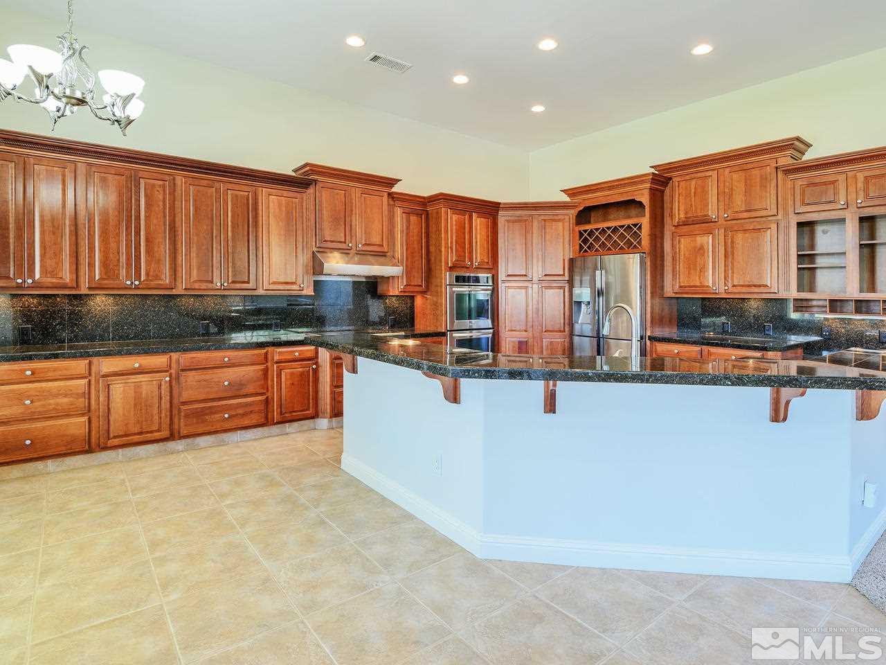 1180 Paddock Lane Reno, NV 89521 - Photo 9 of 25 a kitchen with stainless steel appliances granite countertop a stove a sink and a refrigerator