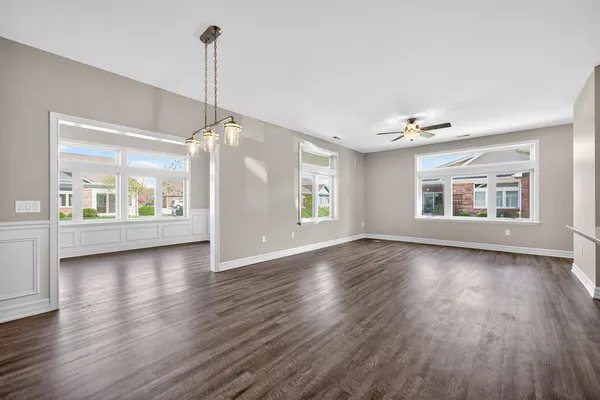 a living room with furniture and wooden floors