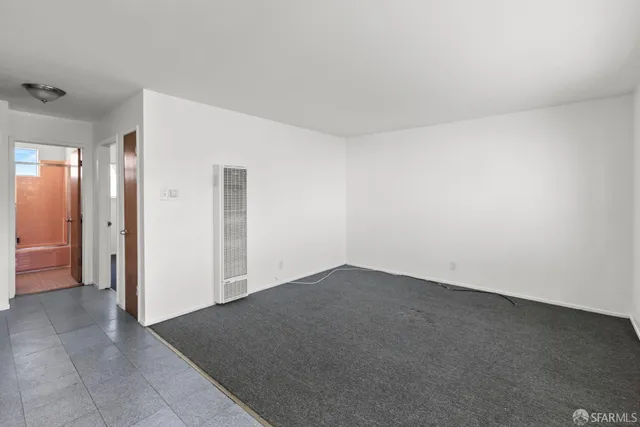 a view of a kitchen with microwave and refrigerator