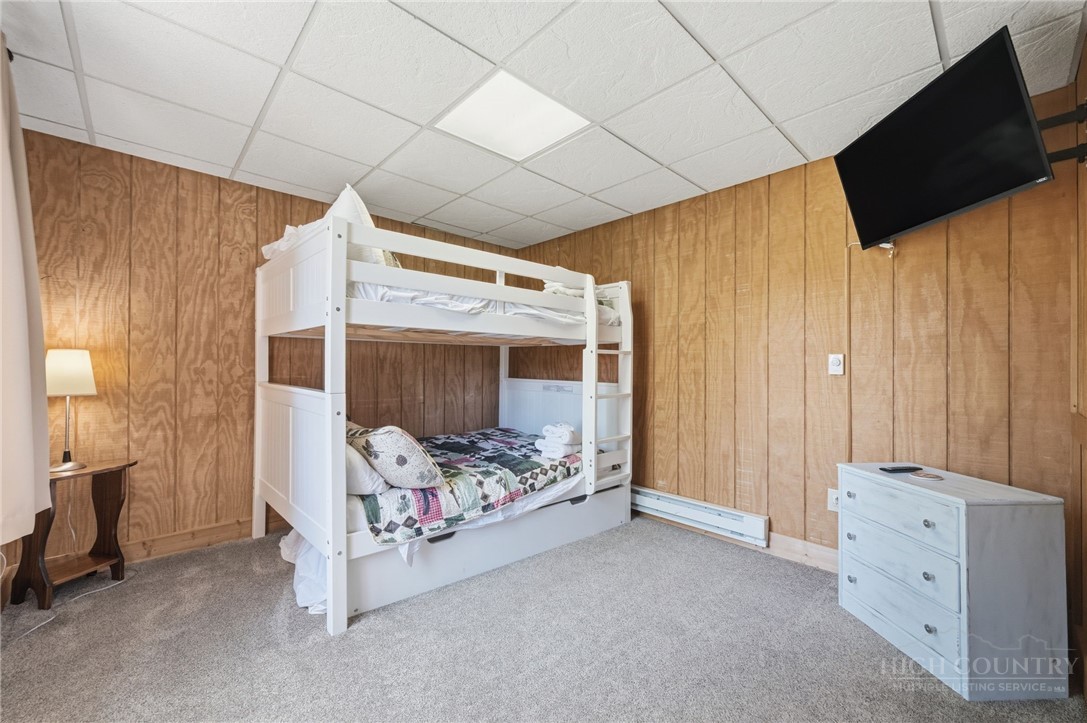 850 River Ridge Road Boone, NC 28607 - Photo 14 of 26 a bedroom with bed and flat tv screen