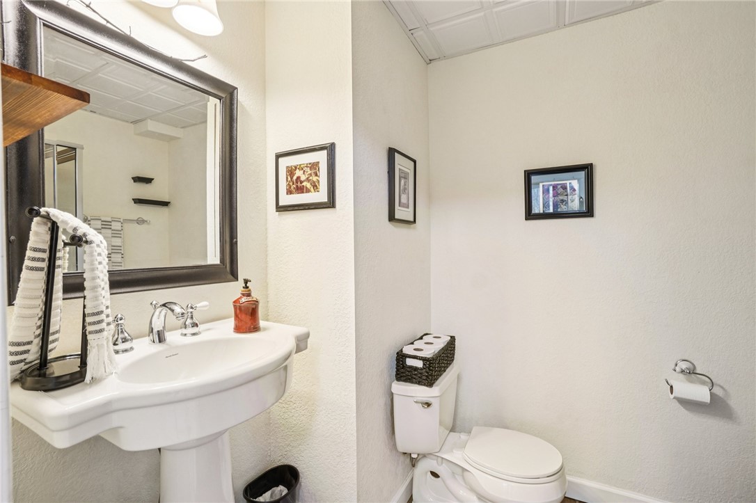 120 Beacon Ridge Circle Salem, SC 29676 - Photo 18 of 48 This bathroom features a contemporary pedestal sink and a toilet, with clean, neutral walls.
