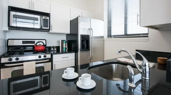 a kitchen with a sink cabinets and appliances