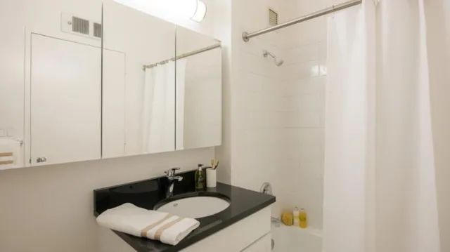 a bathroom with a sink toilet and shower