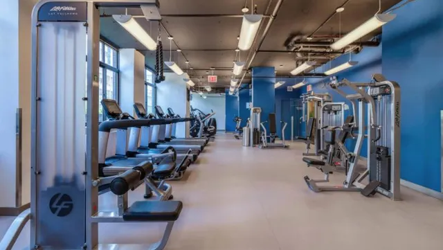 a living room with furniture a window and a chandelier