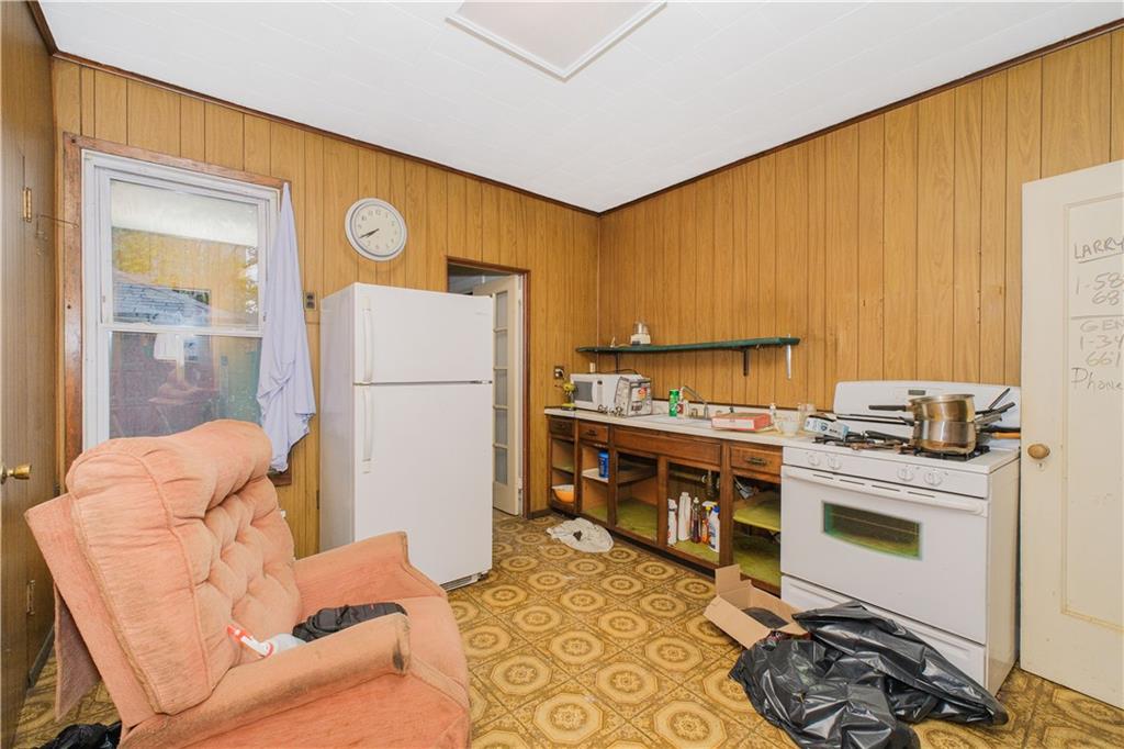 660 85th Street Brooklyn, NY 11228 - Photo 12 of 32 a kitchen with stainless steel appliances granite countertop a refrigerator a stove and a sink