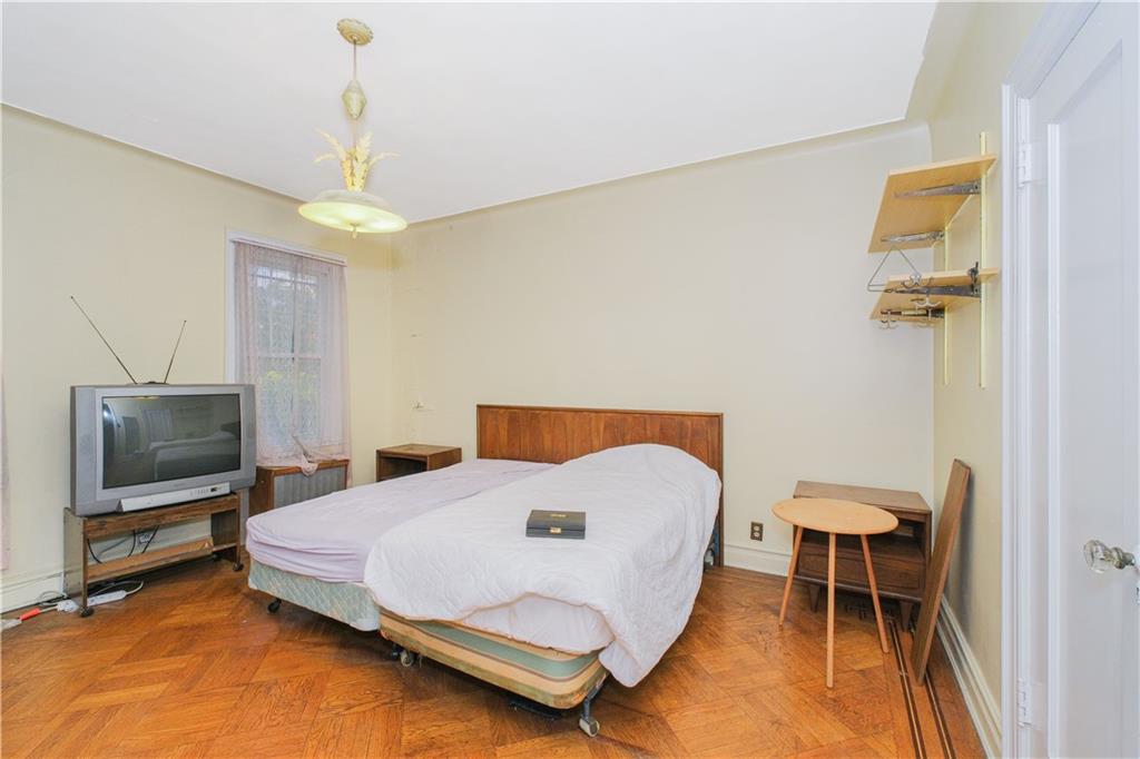 660 85th Street Brooklyn, NY 11228 - Photo 19 of 32 a bedroom with a bed and a television