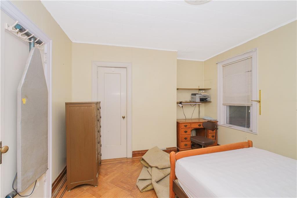 660 85th Street Brooklyn, NY 11228 - Photo 23 of 32 a bedroom with a bed and furniture