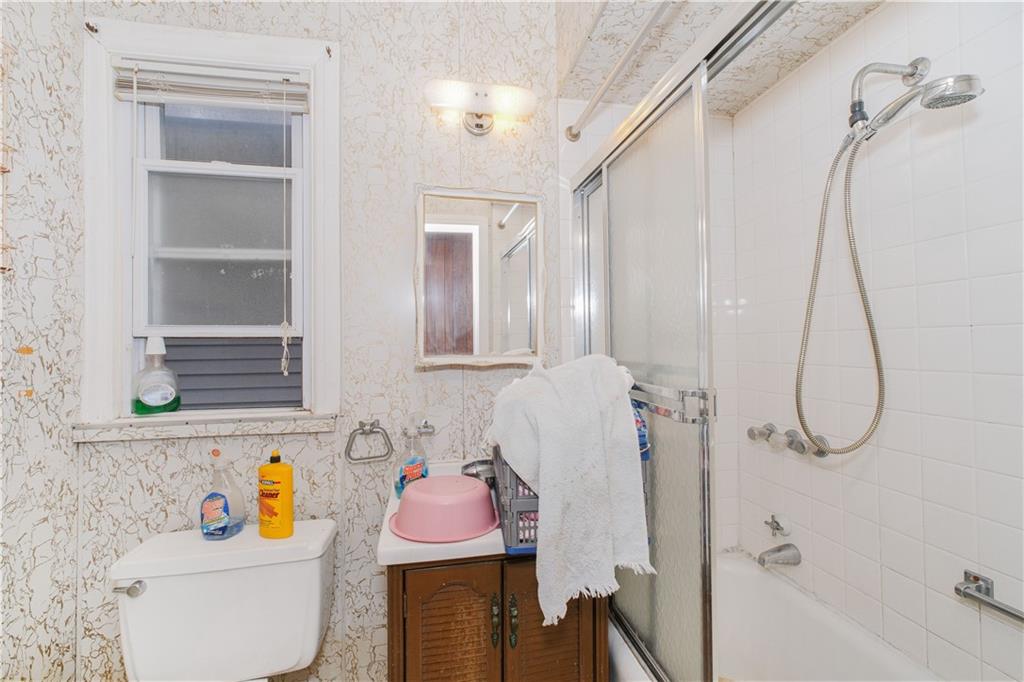 660 85th Street Brooklyn, NY 11228 - Photo 26 of 32 a bathroom with a sink toilet vanity and shower