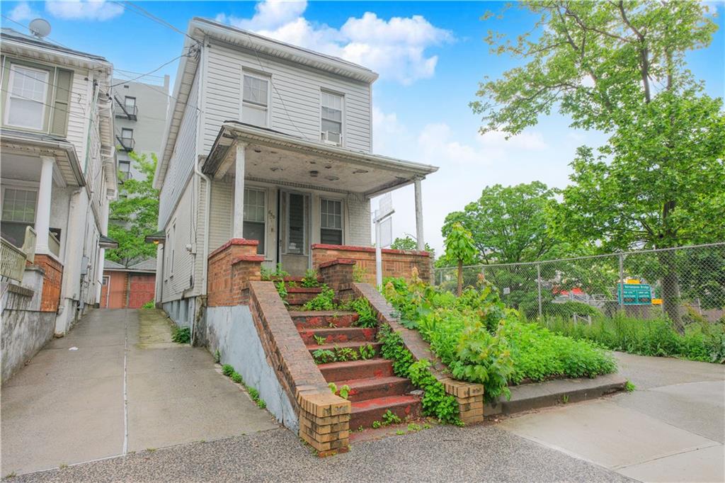 660 85th Street Brooklyn, NY 11228 - Photo 4 of 32 a front view of a house with a yard
