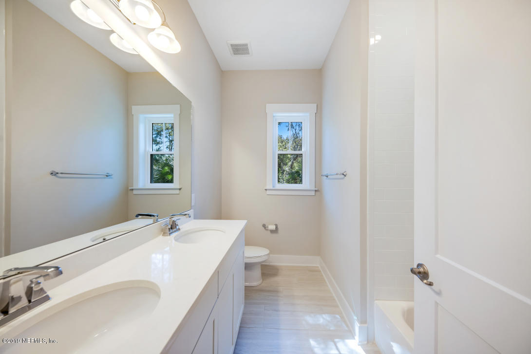 434 Ridgeway Road St. Augustine Beach, FL 32080 - Photo 9 of 23 a bathroom with a sink a toilet and a mirror