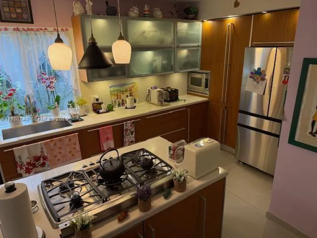 a kitchen with a stove and a refrigerator