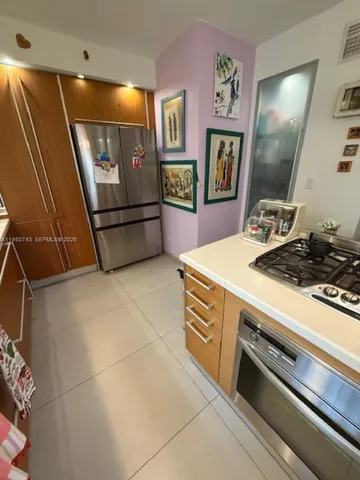 a kitchen with a stove and a refrigerator