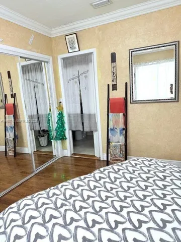 a bedroom with a bed and a mirror