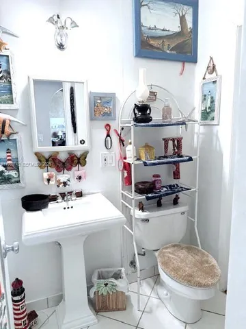 a bathroom with a sink toilet and a mirror