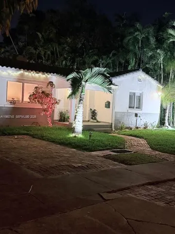 a view of house with yard and green space