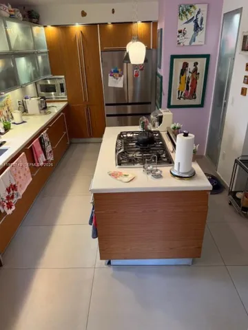 a room with stainless steel appliances granite countertop a stove and a sink